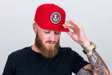 Solid red Snapback with skull logo